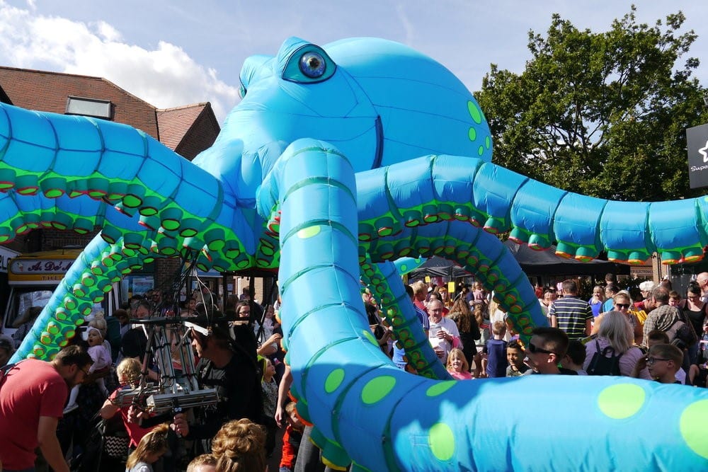 4m high 7m wide Octopus puppet with digital LED lighting outside with a crowd surrounding