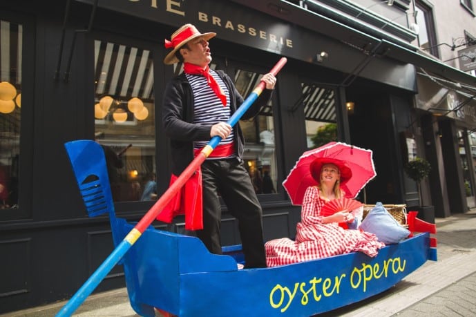 Oyster Opera’s Gondola with singing Gondolier and lady with red umbrella relaxing