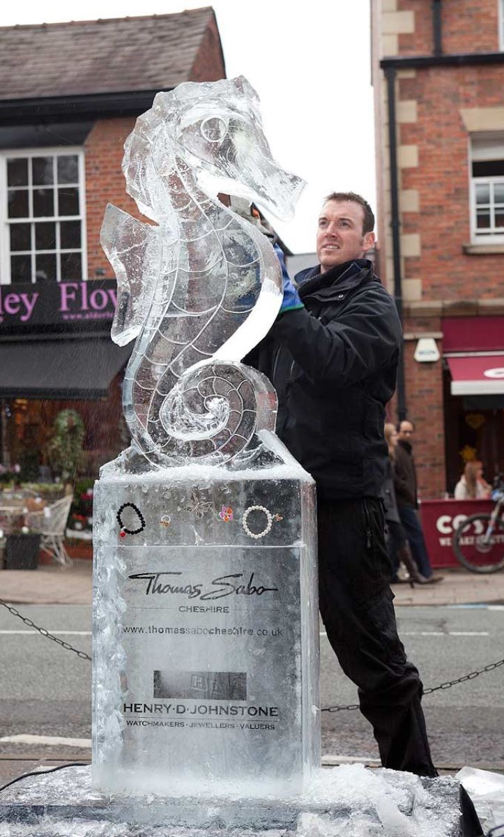 Man carving a seahorse ice sculpture