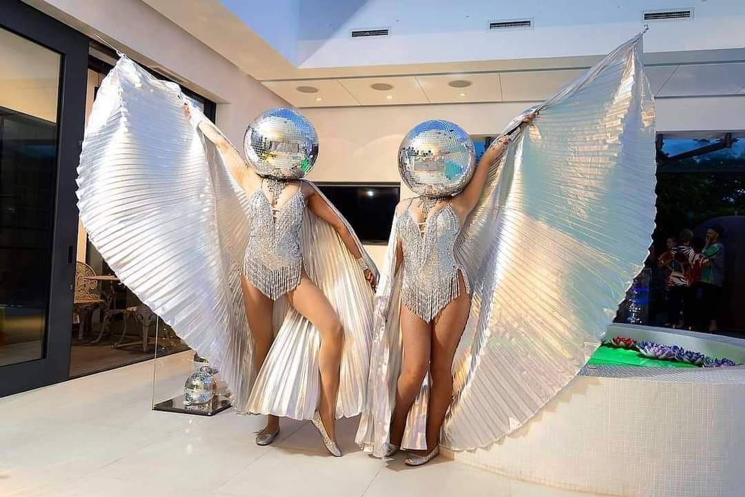 two showgirls with disco heads