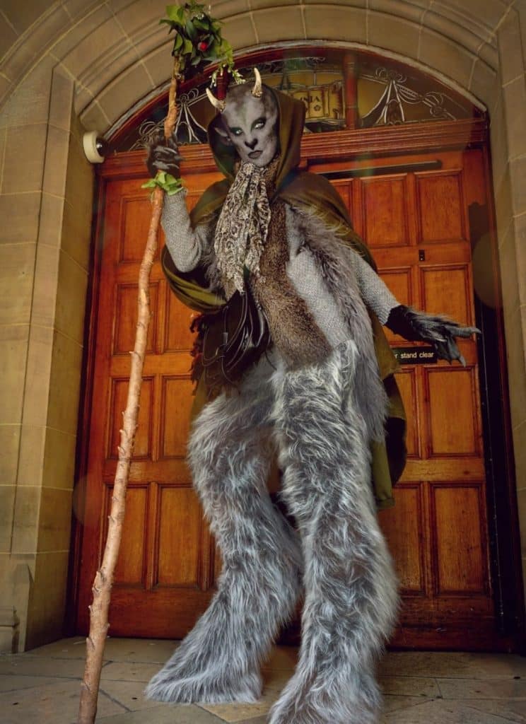 Stilt walker dressed as magical creature